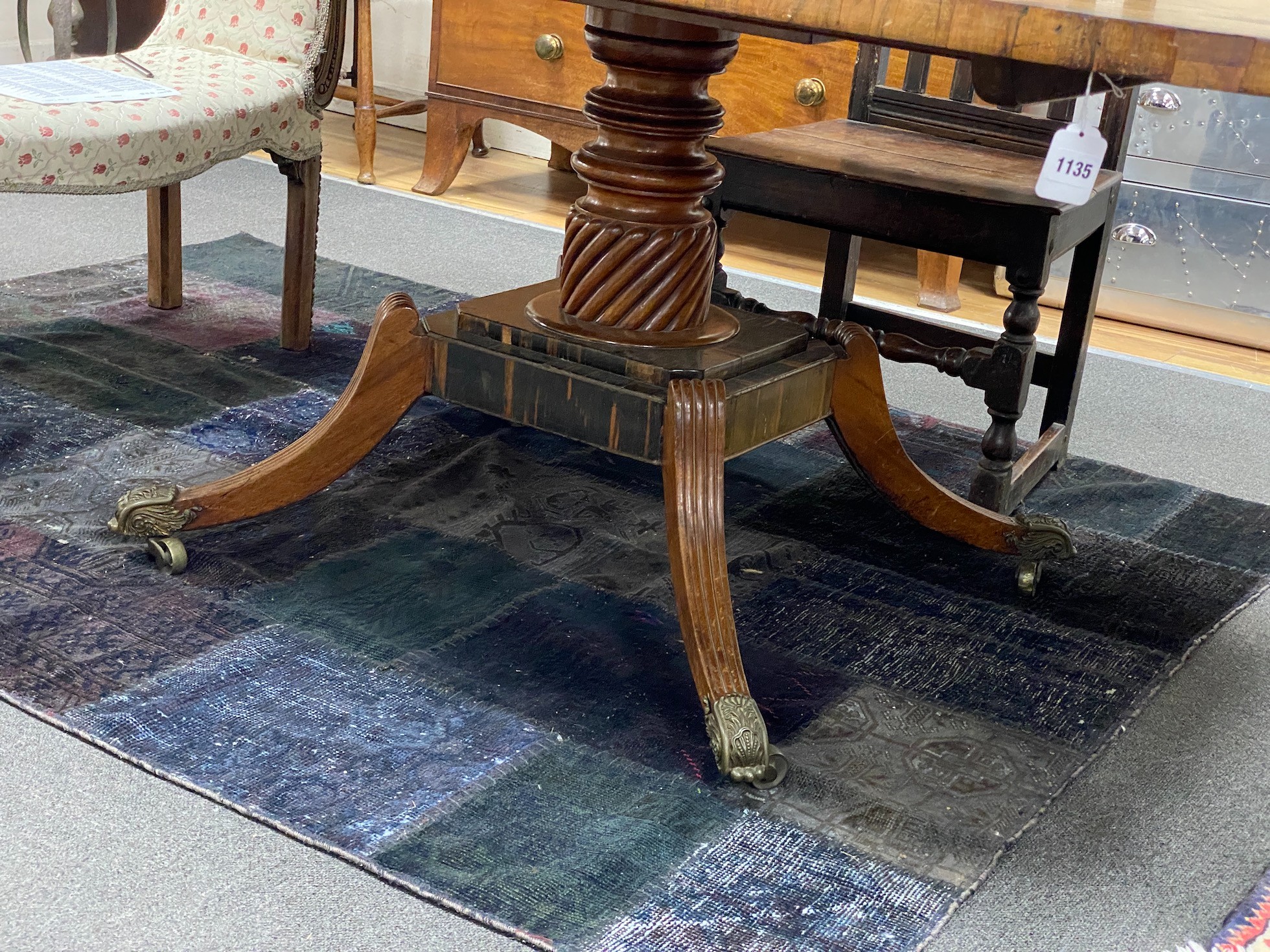 A Regency coromandel banded rectangular mahogany tilt top dining table, length 160cm, width 106cm, height 74cm